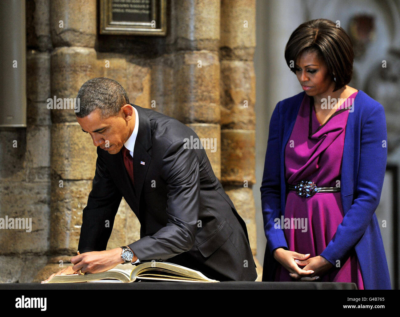 US President Barack Obama, watched by his wife, First Lady Michelle ...