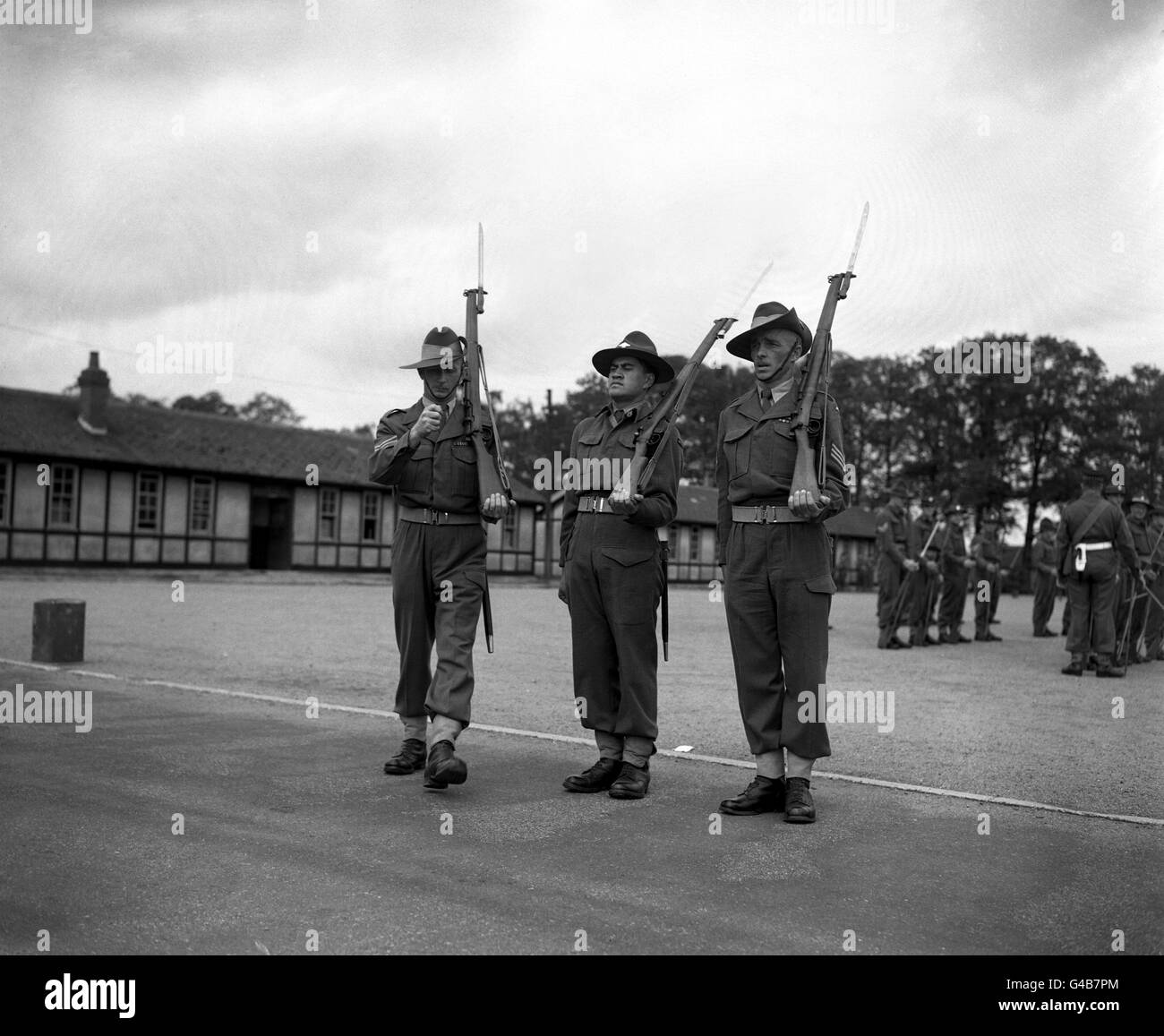 Australians (slouch hats) and New Zealanders change the guard on the square at Pirbright Camp, Surrey rehearsing for when they mount the guard at Buckingham Palace for the Queen's Coronation Stock Photo