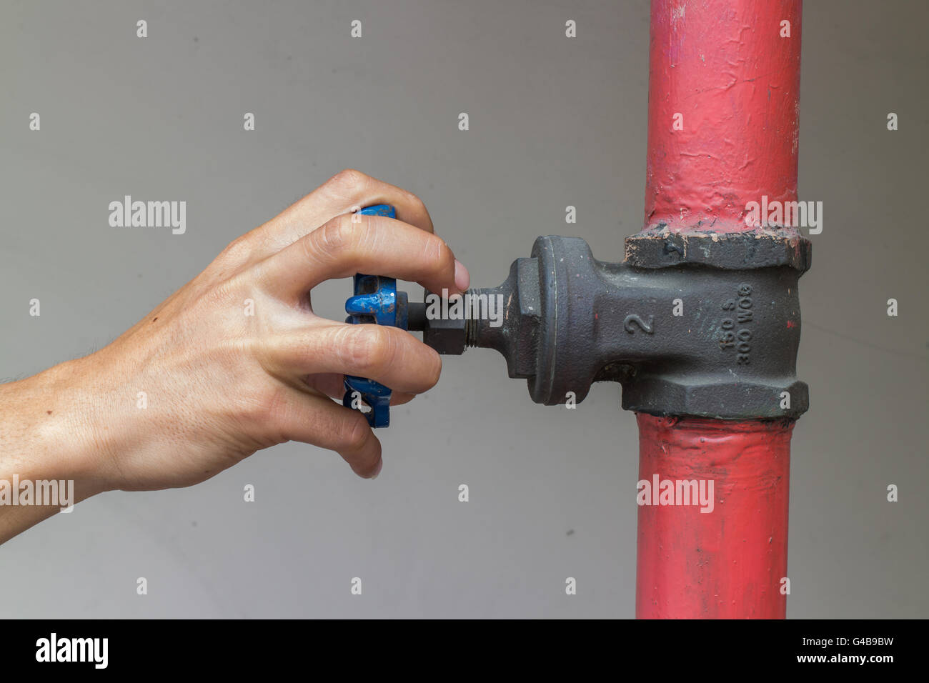 Closeup hands opening Industrial hand valve Stock Photo
