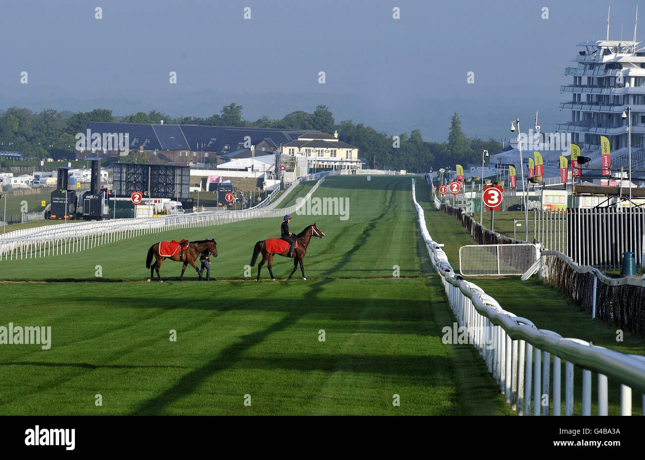 Horse Racing - Investec Derby Festival - Preview Day - Epsom Downs Racecourse. Horses cross the straight on the Gallops at Epsom Downs Racecourse. Stock Photo