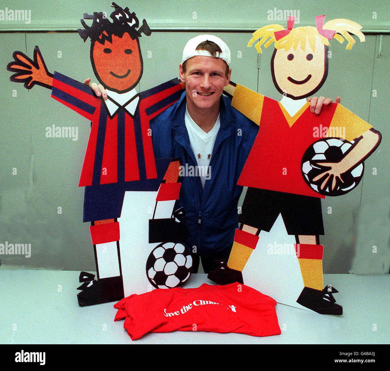 England soccer star Teddy Sheringham during a photocall at Salford Quays in Manchester today (Tuesday) where he launched Save the Children's 'Footie Fundraiser' pin badge campaign which coincides with the World Cup. Save the Children, are hoping to raise 100,000 from the sale of these badges. PA Photos. Stock Photo
