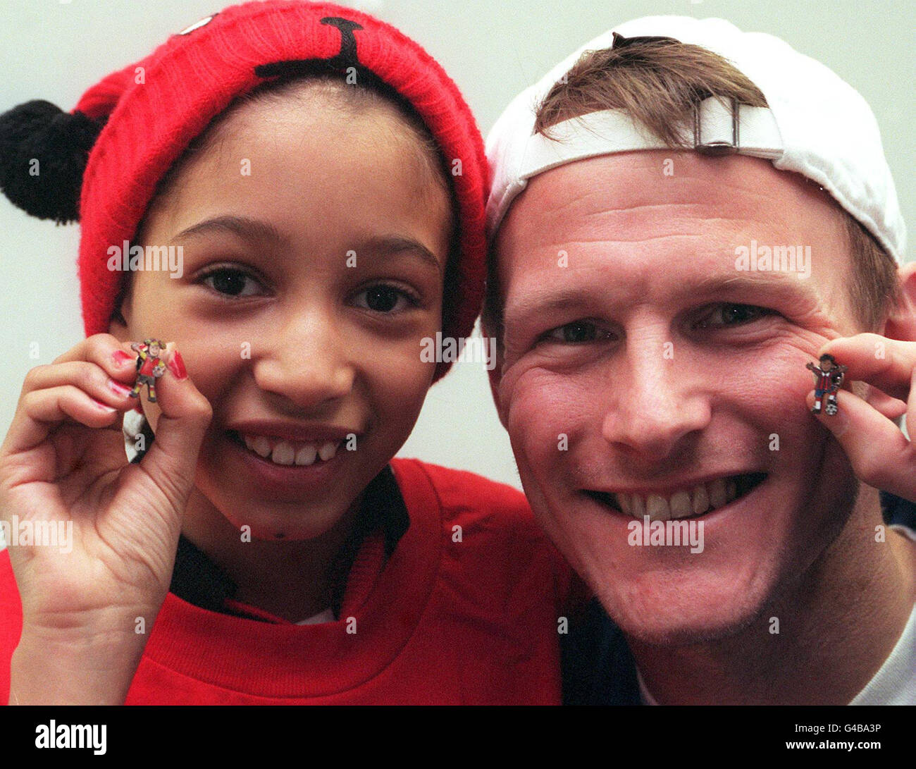 England soccer star Teddy Sheringham with Raine Allen-Miller, aged 8 from Fallowfield, Manchester during a photocall at Salford Quays in Manchester today (Tuesday) where he launched Save the Children's 'Footie Fundraiser' pin badge campaign which coincides with the World Cup. Save the Children, are hoping to raise 100,000 from the sale of these badges. PA Photos. Stock Photo
