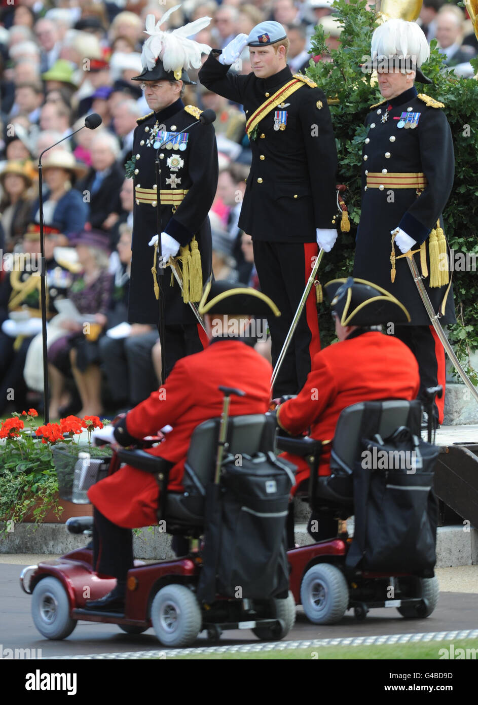 Prince Harry salutes Chelsea Pensioners during the Founder's Day Parade at the Royal Hospital Chelsea, London. Stock Photo