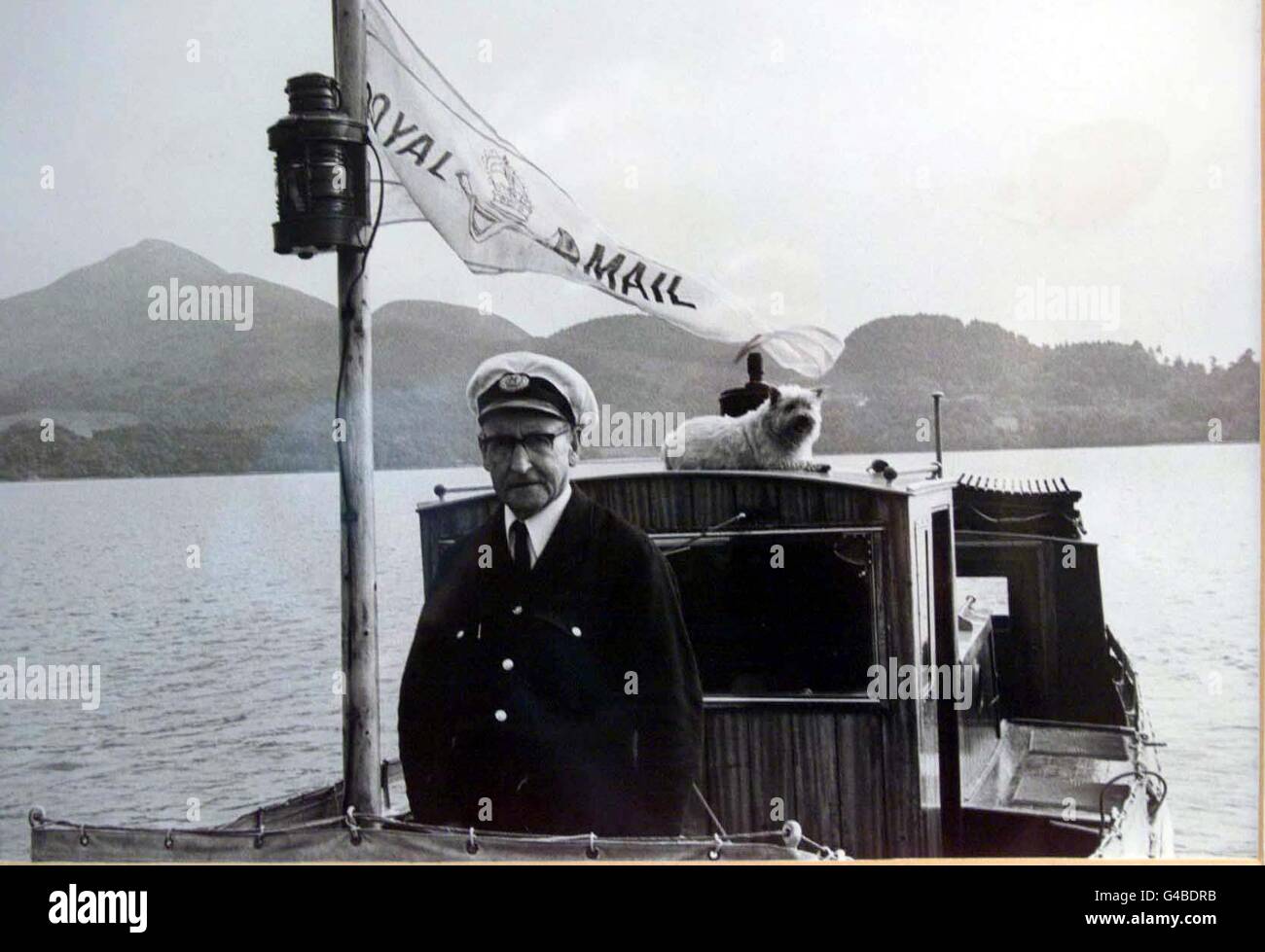 Sandy Macfarlane's grandfather Alex (right) delivering the post on Loch Lomond . For 50 years, three generations of the Macfarlane family have been delivering mail to people living on tiny islands dotted on Loch Lomond from thier boatyard at Bamaha. EDI Photo by Chris Bacon/PA Stock Photo