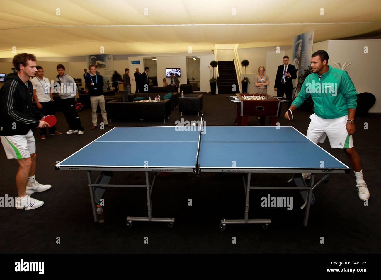 Great Britain's Andy Murray (left) and France's Jo-Wilfried Tsonga play table  tennis in the players lounge as rain delays play during day Seven of the  AEGON Championships at The Queen's Club, London