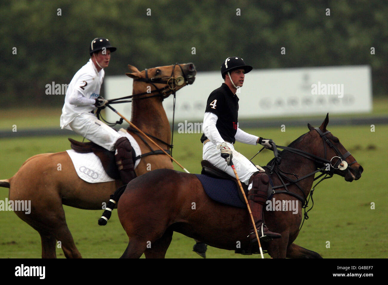 The Duke of Cambridge (Black 4) takes part in a charity polo tournament against a team including his brother Prince Harry (White 2), in aid of disadvantaged African children, at Cowarth Park, Sunninghill, near Ascot. Stock Photo