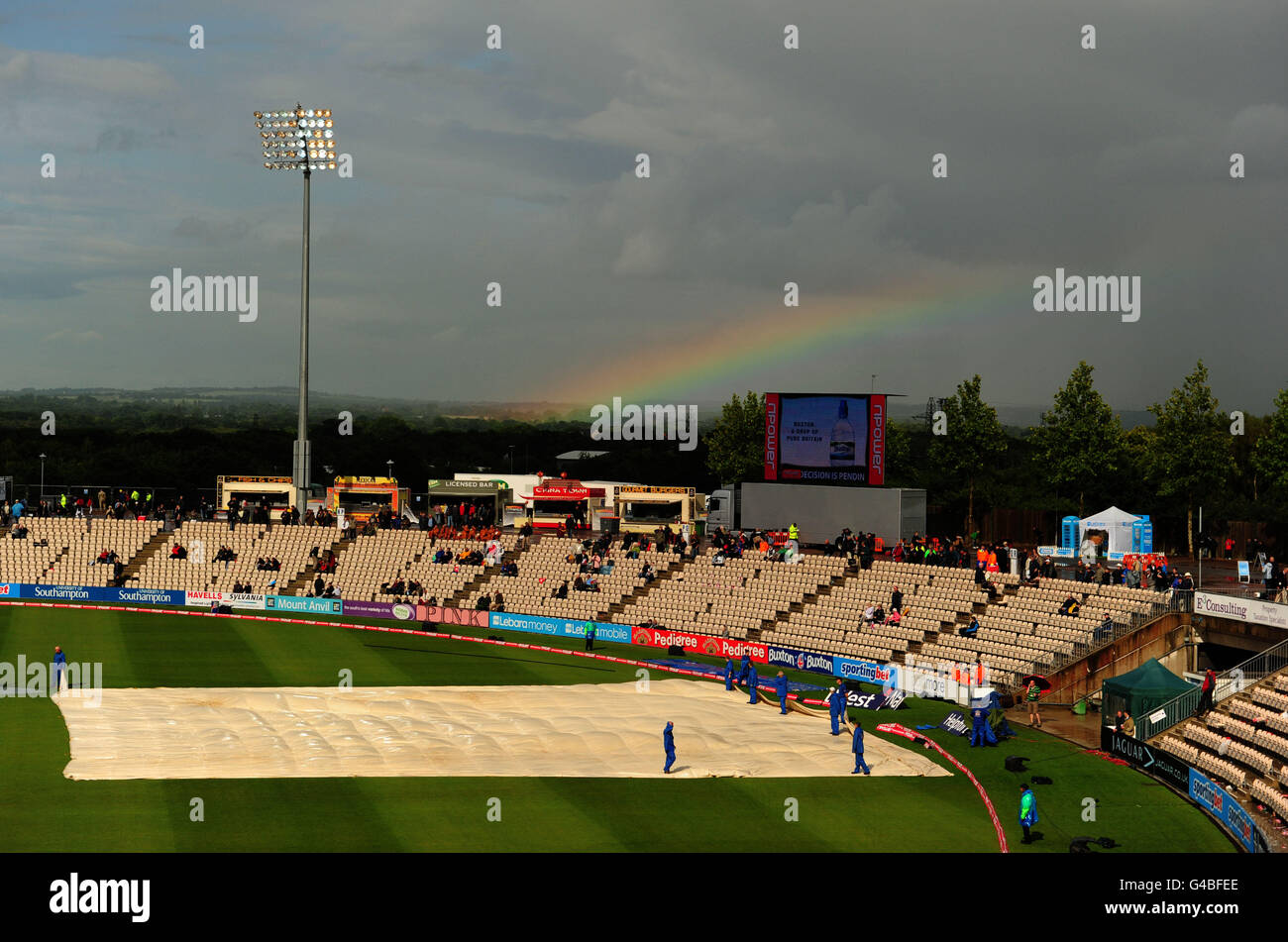 Cricket - npower Third Test - England v Sri Lanka - Day One - The Rose Bowl. A rainbow appears on the horizon as the covers are brought on yet again Stock Photo