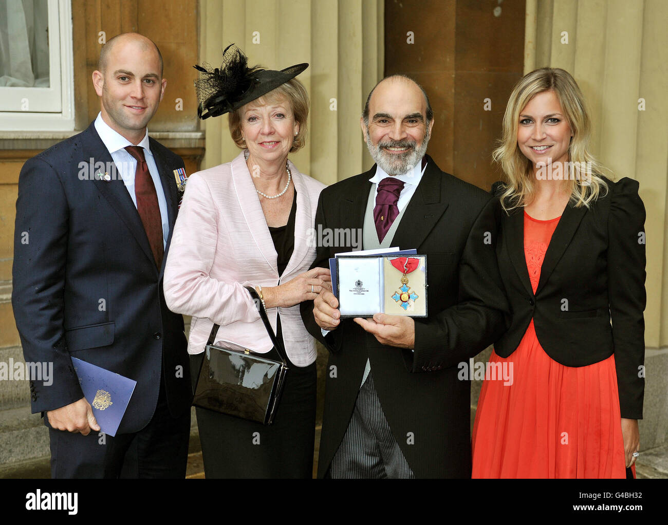 Actor David Suchet (2nd right) with son Robert (left), wife Sheila (2nd left), and daughter Katherine (right), as he proudly holds his CBE after it was presented to him by the Prince of Wales at the Investiture Ceremony in Buckingham Palace in central London. Stock Photo