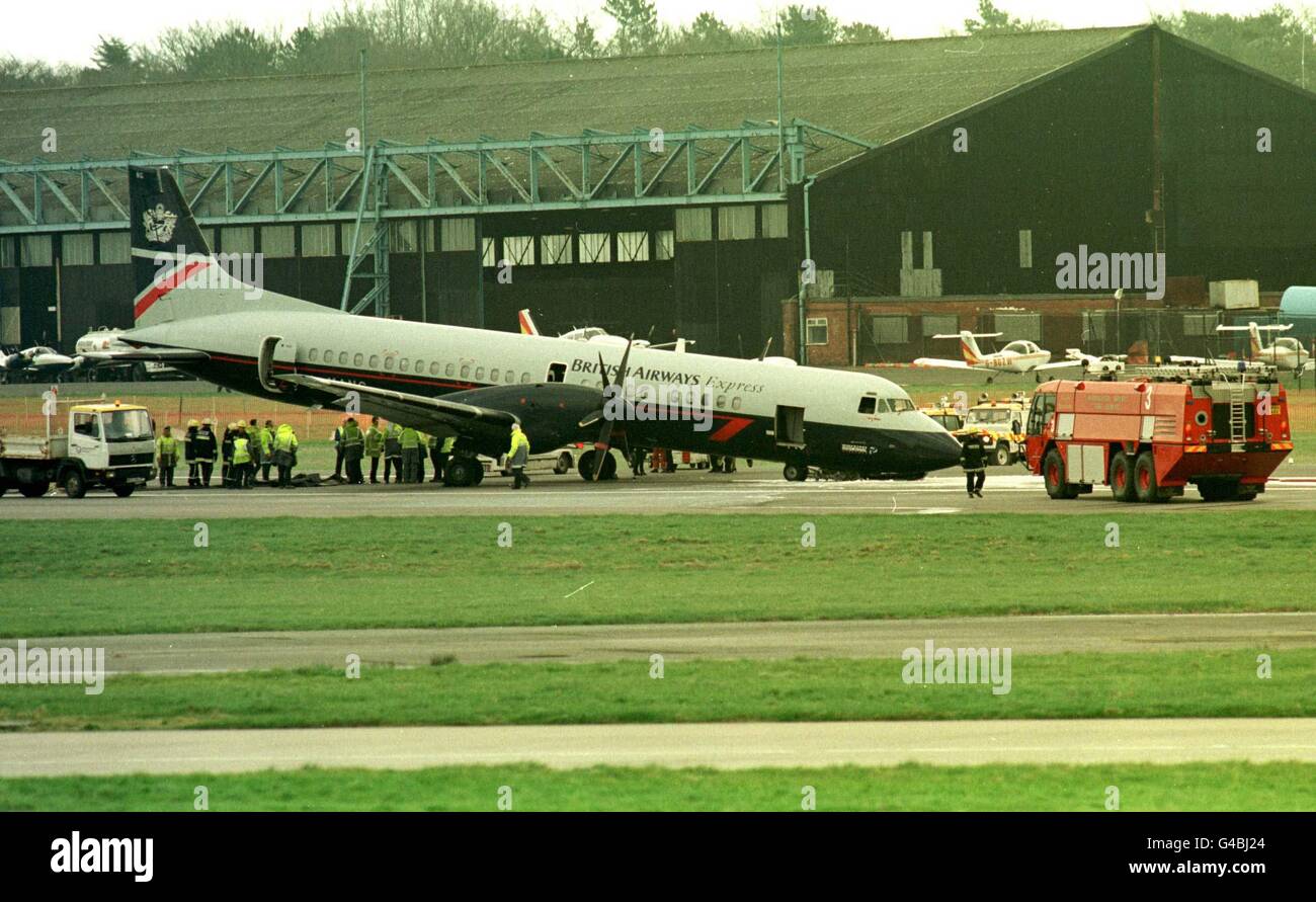 A British Airways twin-engined ATP aircraft lies on the runway at Manchester Airport today (Wed) after the nosewheel collapsed on landing. Fifty-eight passengers on board the flight were evacuated to saftey by emergency chute See PA story AIR Plane./PA PA Photo by Malcolm Croft Stock Photo