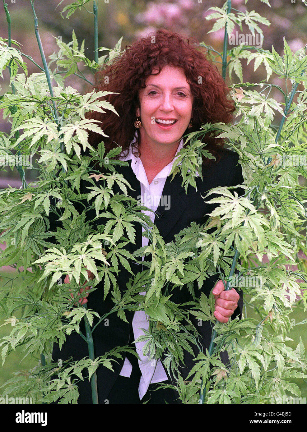 Body Shop founder Anita Roddick surrounded by artificial Hemp plants