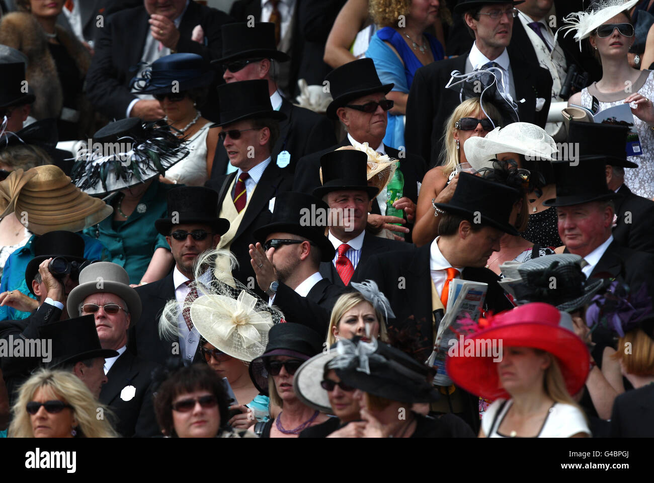 Horse Racing - Investec Derby Festival - Investec Derby Day - Epsom Downs Racecourse. Smartly dressed racegoers watch the action from the stands Stock Photo