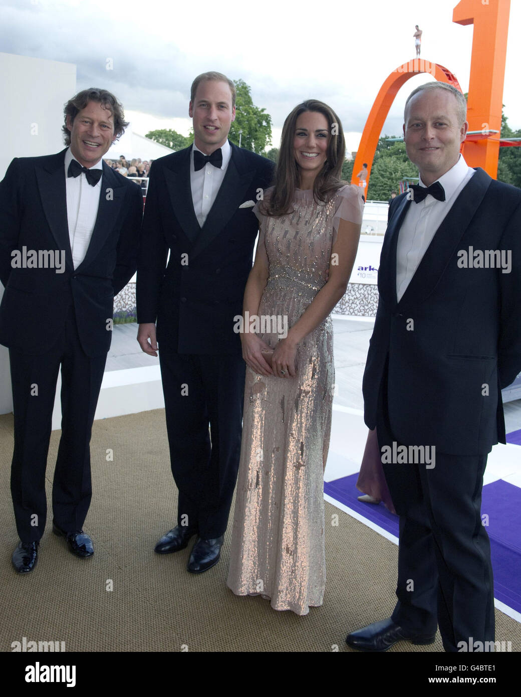 The Duke and the Duchess of Cambridge attended at the 10th annual ARK (Absolute Return for Kids) Gala Dinner on behalf of The Foundation of Prince William and Prince Harry at Perks Field, Kensington Palace, along with co founders Arpad Busson (left) and Ian Wace (right). Stock Photo