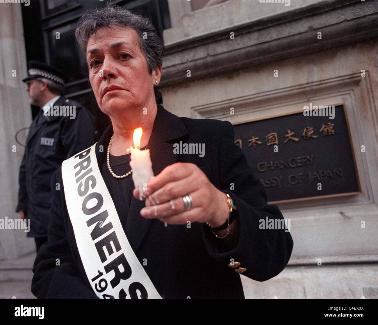 Joan Bulley a civilian internee from the age of 4-7 in Lung Hua Prison Camp in Shanghai Prison during the 2nd World War, takes part in a candle light vigil outside the japanese Embassy in central london this evening (Monday). Photo by Justin Williams/PA Stock Photo