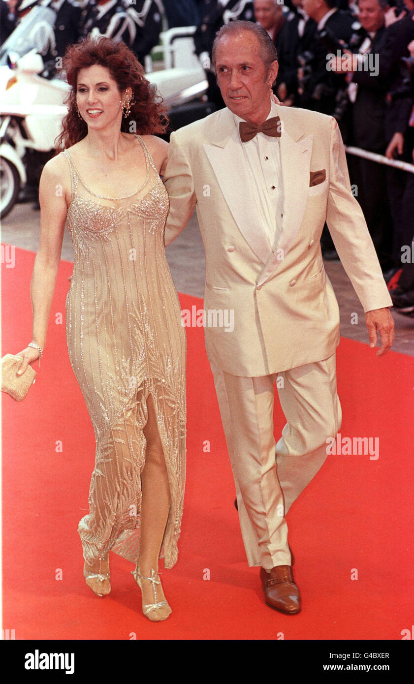 Actor David Carradine and his wife arrive for the premiere of Godzilla, the closing film of the 51st Cannes Film Festiival, in Cannes, France. Stock Photo