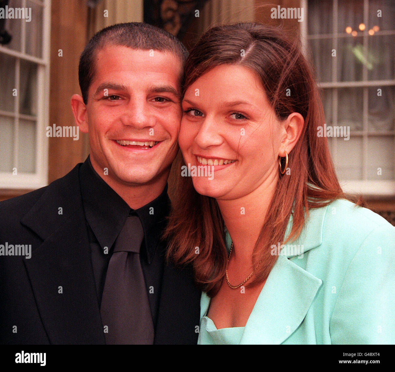 Boxer Spencer Oliver, who suffered a blood clot on his brain during a recent title fight, with fiancee Louise Taylor, at Buckingham Palace today (Monday) where the Queen gave a reception for more than 900 young achievers. See PA story ROYAL Achievers. Photo by Tony Harris/PA Stock Photo