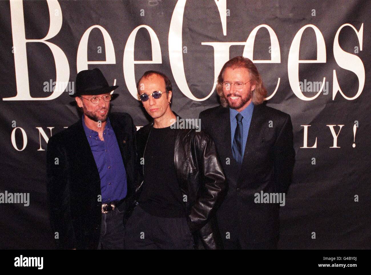 The Bee Gess (from left) Maurice, Robin and Barry Gibb pose for the media during a photocall at London's Cafe Royal today (Tuesday) where they unveiled plans for a leisurely world tour, 31 years after their first hit. Photo by Andrew Stuart/PA. See PA story SHOWBIZ Bee Gees Stock Photo