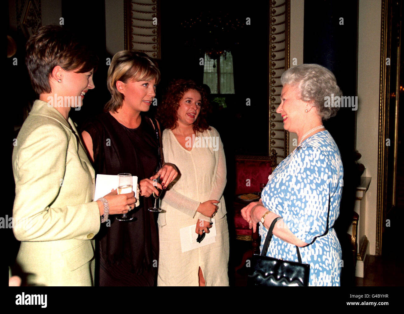 PA NEWS PHOTO 1/6/98 The Queen chats to ITN's Katie Derham, Channel 5 presenter Kirsty Young and actress Julia Sawalha at Buckingham Palace, London today (Monday) where she gave a reception for more than 900 young achievers. See PA story ROYAL Achievers. Photo by Tony Harris/PA Stock Photo