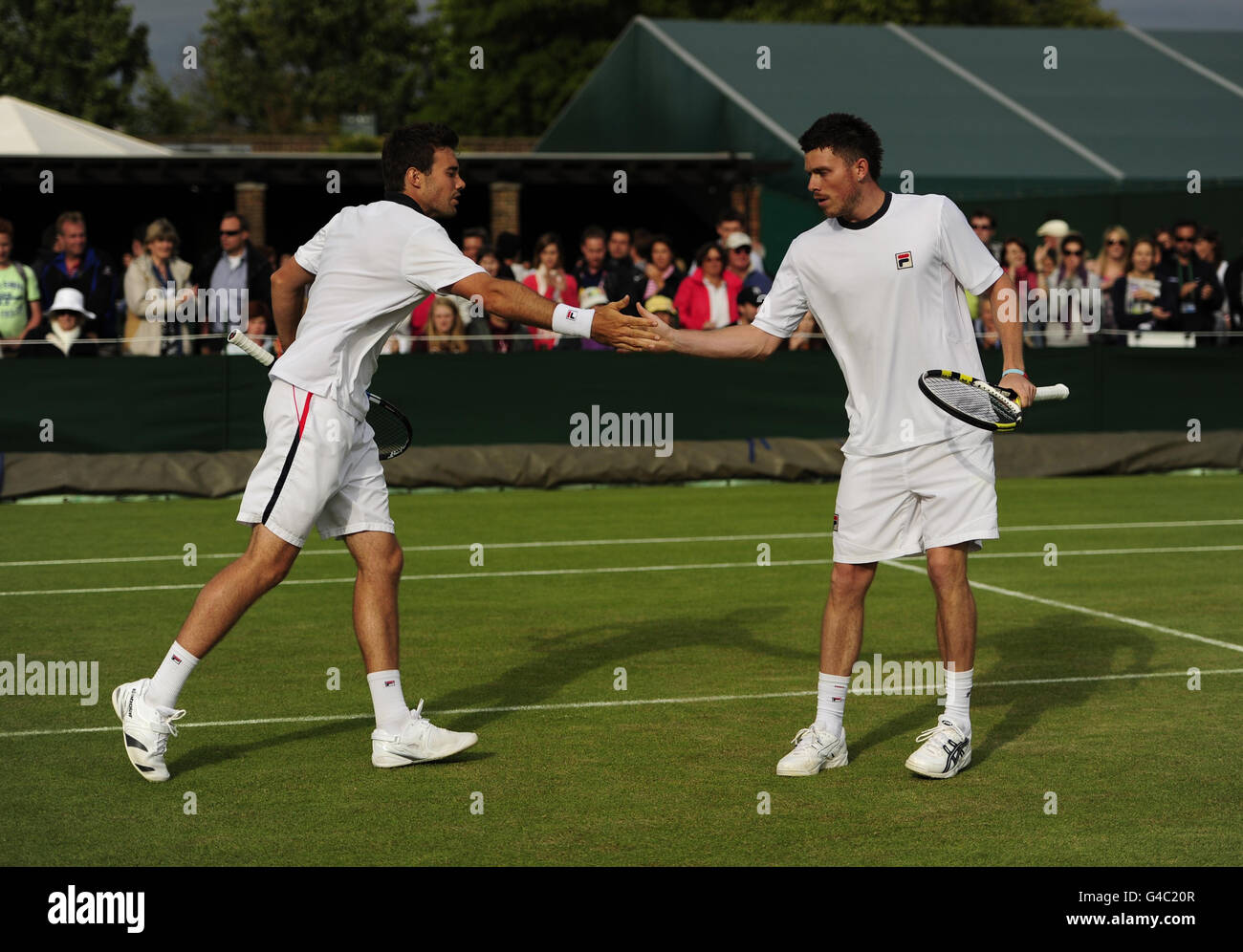 Great Britain's Josh Goodall and Chris Eaton (left) in their doubles match against Sweden's Robert Lindstedt and Romania's Horia Tecau during Day four of the 2011 Wimbledon Championships at the All England Lawn Tennis and Croquet Club, Wimbledon. Stock Photo