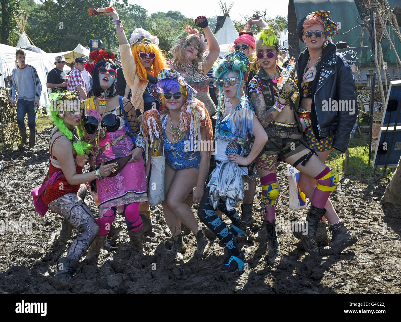Revellers pose for a photograph at Glastonbury music festival at Worthy Farm, Pilton, Somerset. Stock Photo