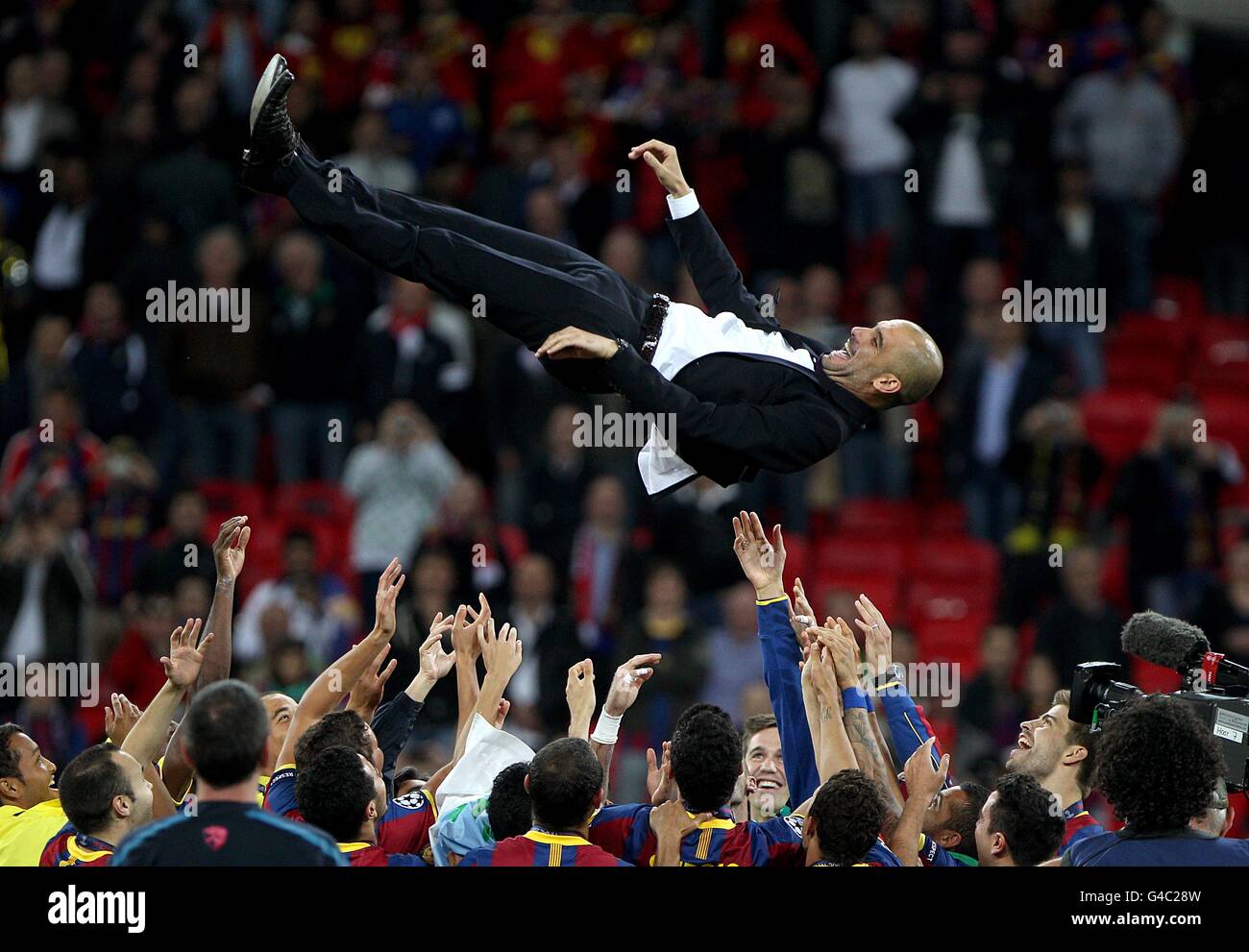 Barcelona manager Josep Guardiola is thrown into the air by his players after winning the UEFA Champions League Final Stock Photo