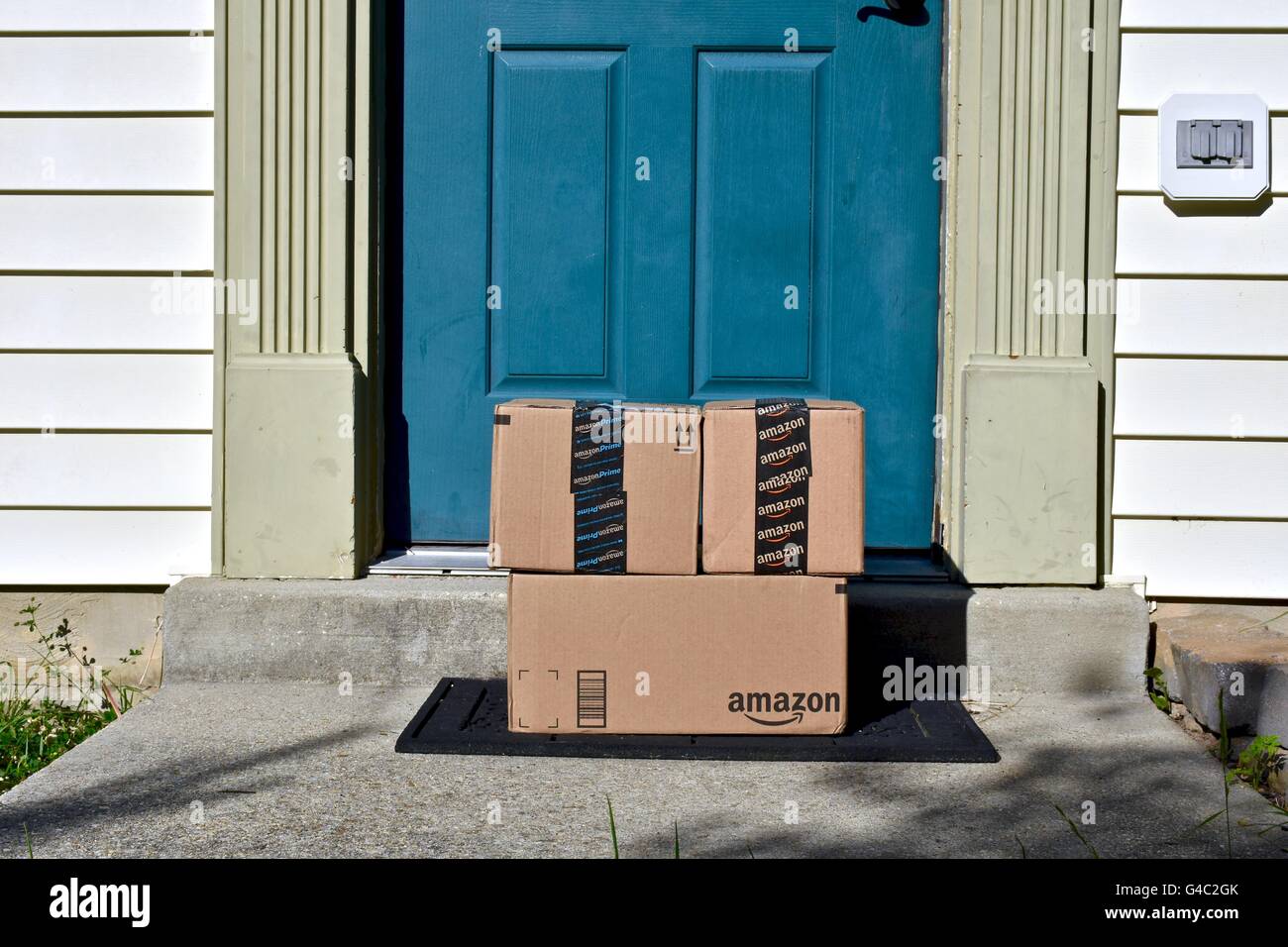 Amazon Prime boxes delivered to the front door of a home Stock Photo