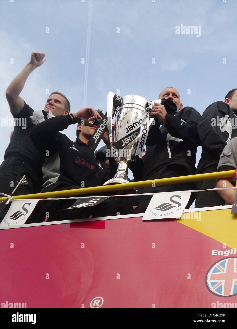 Soccer - Swansea Premier League Promotion Parade. The Swansea City team on top of the bus after it arrived at Swansea Guildhall during the bus parade through Swansea. Stock Photo