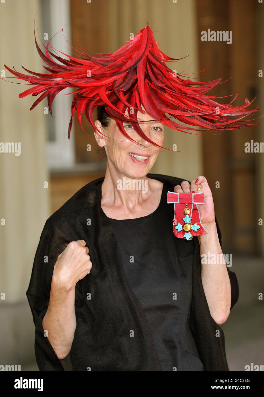 Fashion designer Katharine Hamnett proudly holds her Commander of the British Empire (CBE) medal, after it was presented to her by Queen Elizabeth II at Buckingham Palace in central London following an Investiture Ceremony. Stock Photo