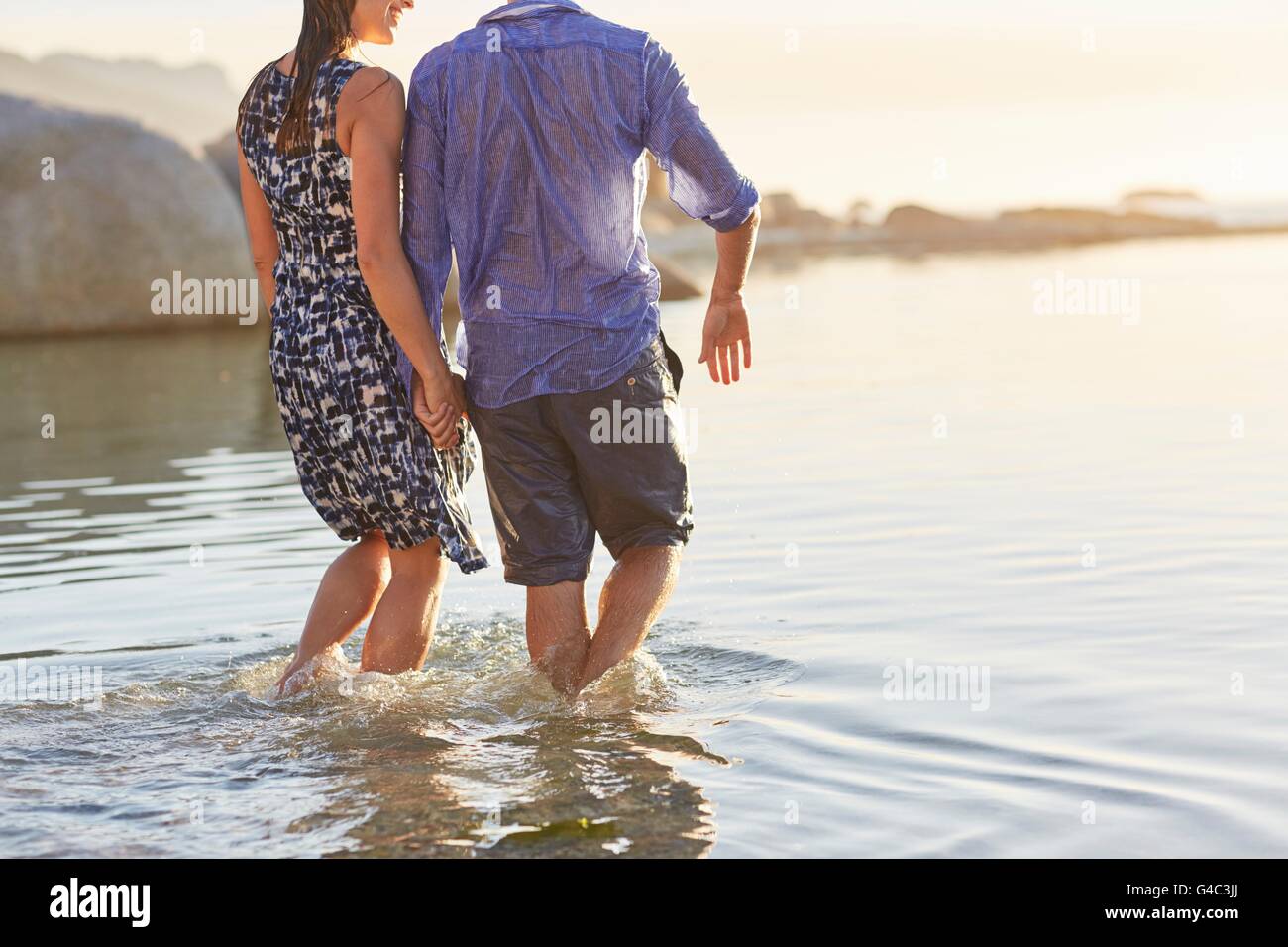 MODEL RELEASED. Couple paddling in the sea. Stock Photo