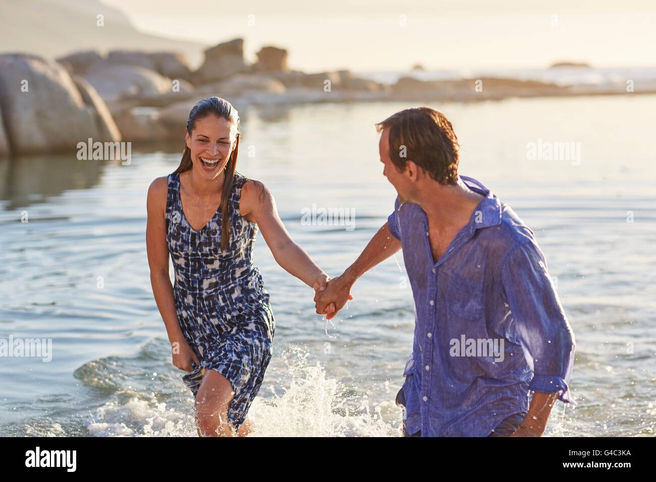 MODEL RELEASED. Couple paddling in the sea. Stock Photo