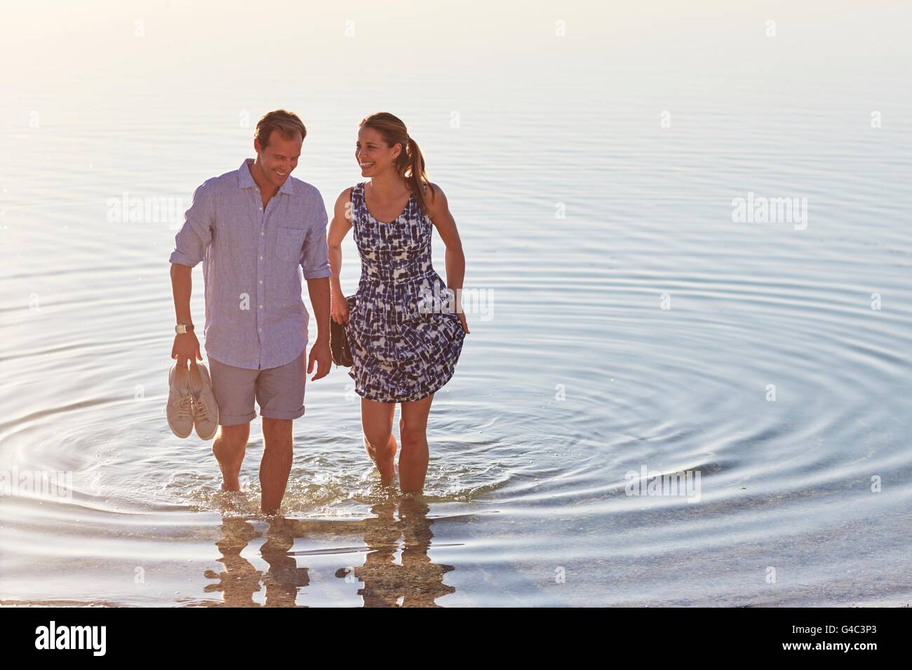 MODEL RELEASED. Couple paddling in the sea. Stock Photo
