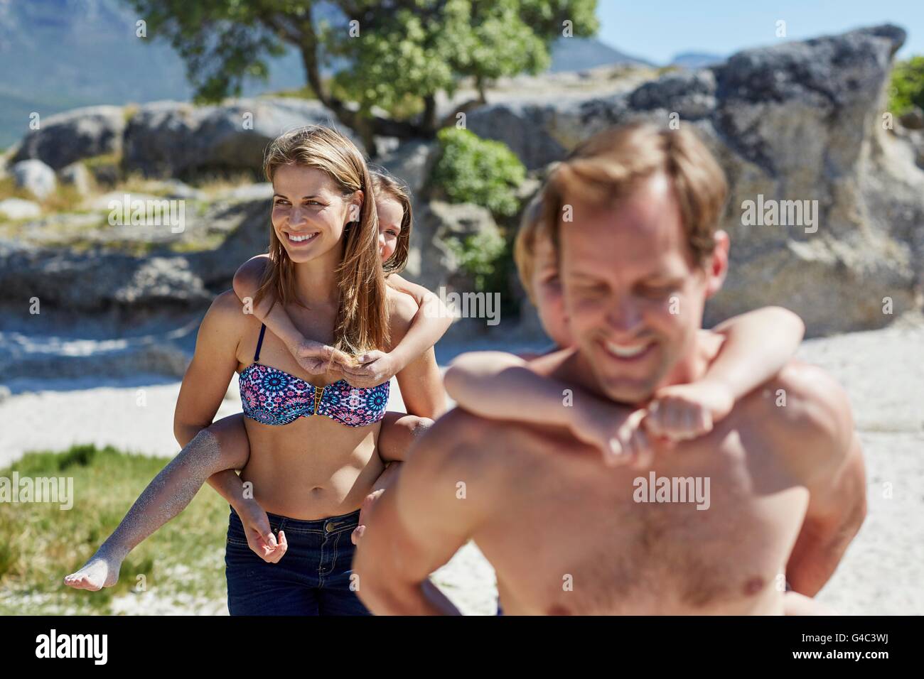 MODEL RELEASED. Parents giving children piggy backs. Stock Photo