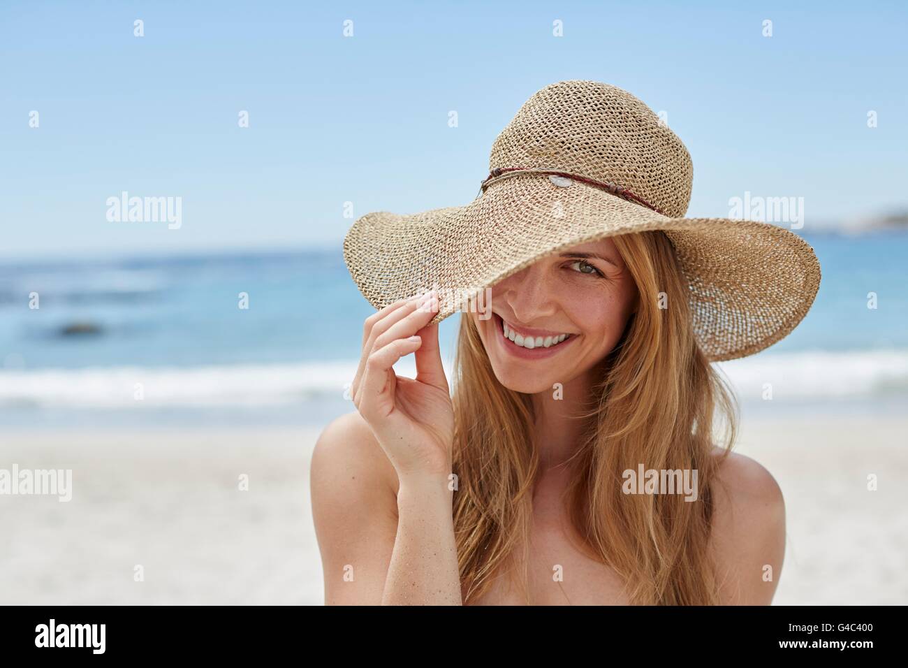 MODEL RELEASED. Young woman wearing a sunhat, portrait. Stock Photo