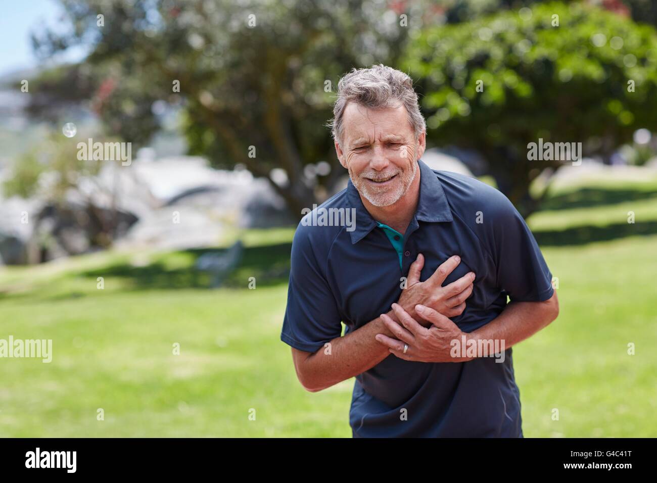 MODEL RELEASED. Senior man holding his chest in pain. Stock Photo
