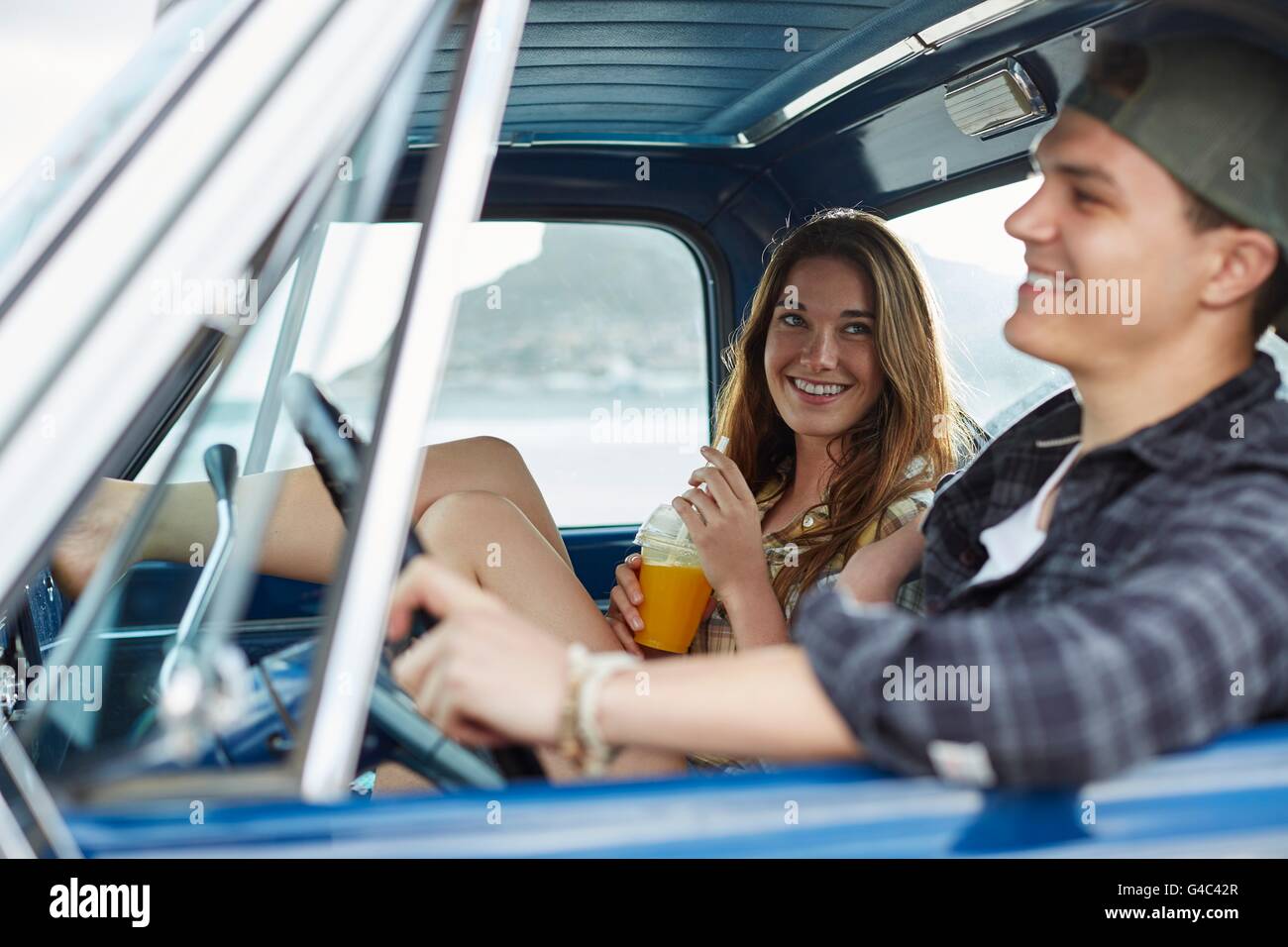 MODEL RELEASED. Young couple in a car, laughing. Stock Photo