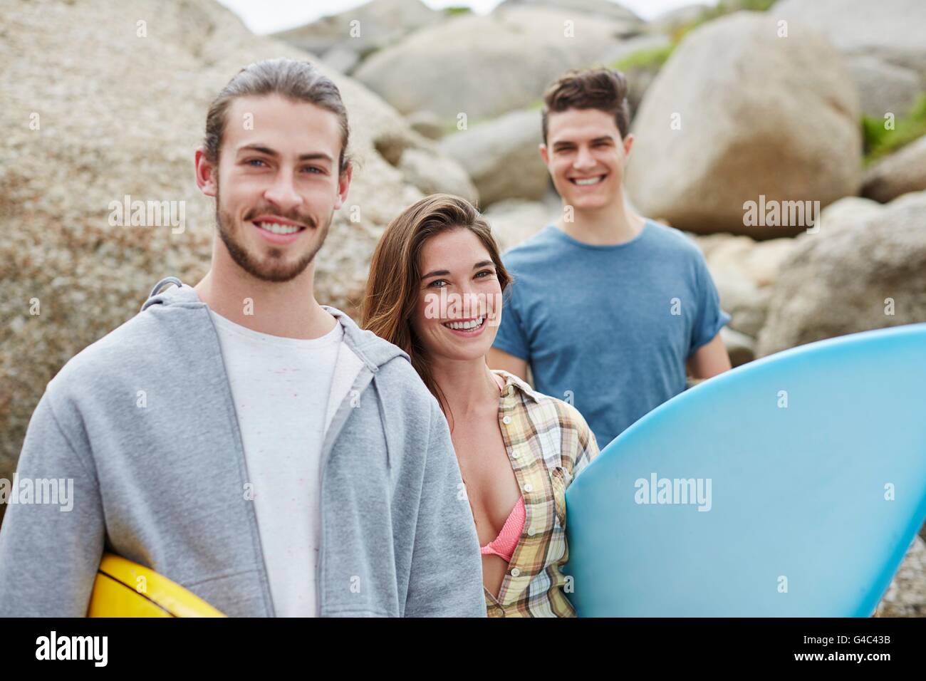 MODEL RELEASED. Young adults with surfboard. Stock Photo