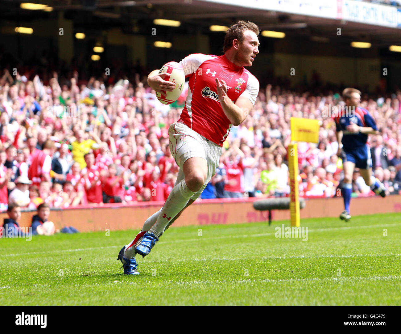 Wales' Morgan Stoddart crosses for a try during the 130th Anniversary Celebration Game at the Millennium Stadium, Cardiff. Stock Photo