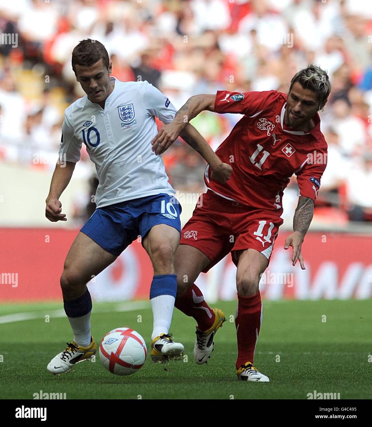 Soccer - UEFA Euro 2012 - Qualifying - Group G - England v Switzerland - Wembley Stadium. Switzerland's Valon Behrami (right) and England's Jack Wilshere battle for the ball. Stock Photo