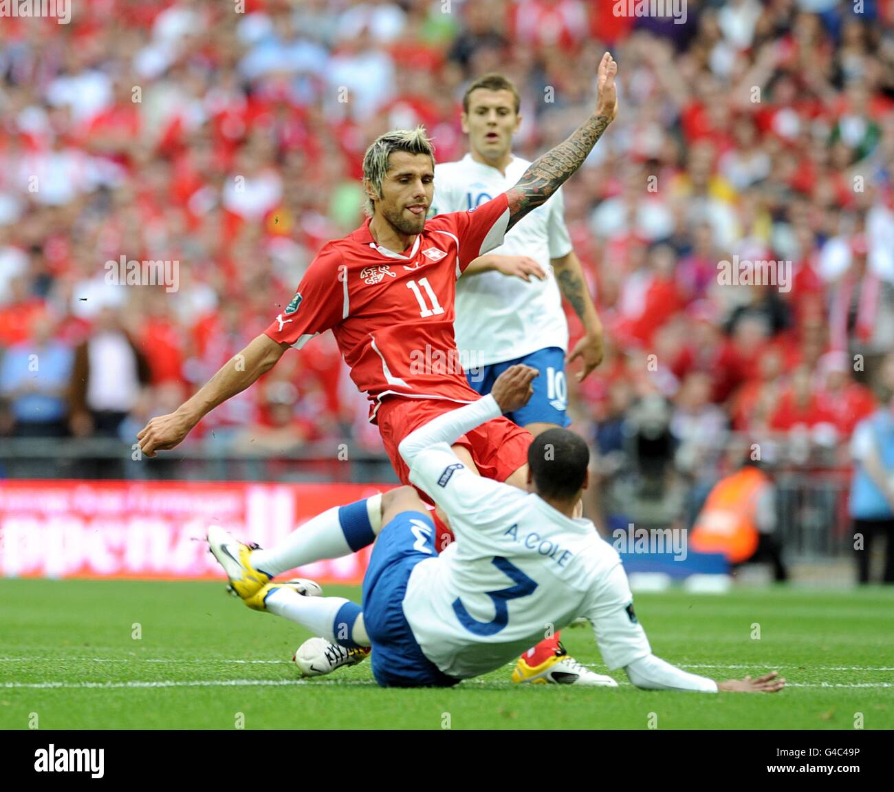 Soccer - UEFA Euro 2012 - Qualifying - Group G - England v Switzerland - Wembley Stadium. England's Ashley Cole (3) and Switzerland's Valon Behrami battle for the ball. Stock Photo