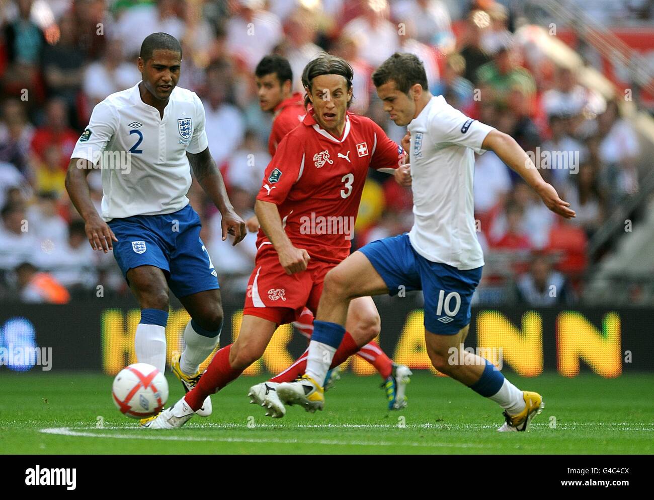 Soccer - UEFA Euro 2012 - Qualifying - Group G - England v Switzerland - Wembley Stadium. England's Jack Wilshere (right) and Switzerland's Reto Ziegler (centre) battle for the ball Stock Photo