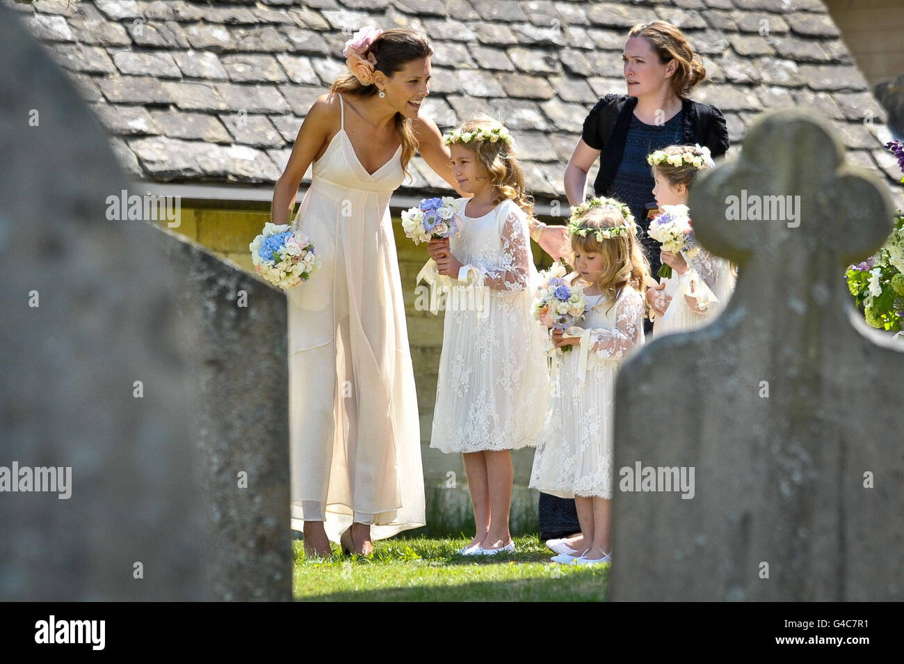 Lily Allen's bridesmaids wait for her to arrive at St James The Great Church in Cranham for her wedding to Sam Cooper. Stock Photo