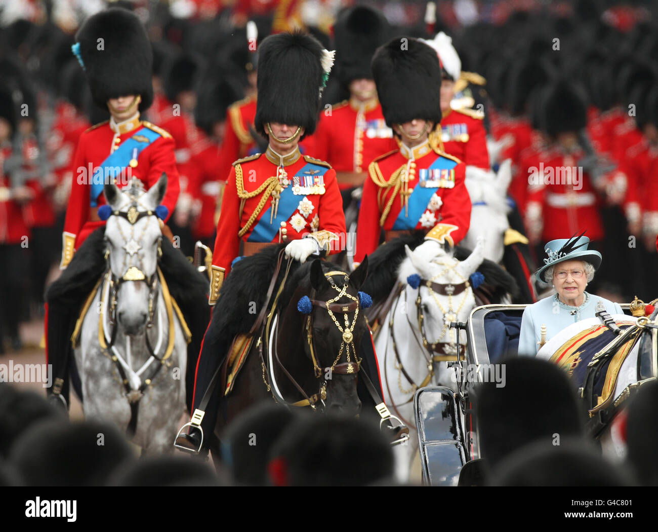 Britain's Queen Elizabeth II returns by horse drawn carriage to Buckingham Palace, London, followed by (left to right) the Duke of Cambridge, The Prince of Wales, and the Duke of Kent after attending Trooping the Colour, the Queen's annual birthday parade. Stock Photo