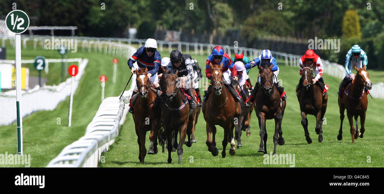 Barney Rebel ridden by Michael Hills (black cap) wins after a tussle with Tullius ridden by Ian Morgan (white cap) The Bet On totplacepot AT toteport.com Handicap Stakes during the totepool Irish Day at Sandown Park Racecourse, Surrey. Stock Photo