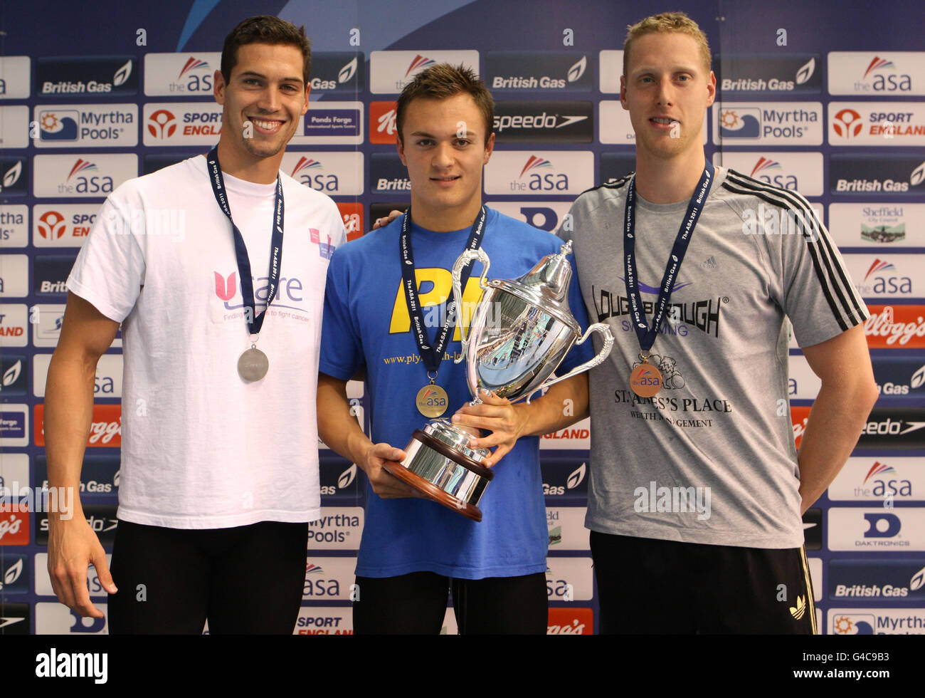 British swimmer Anthony James (Gold) with Simon Burnett (Silver) and Joseph Roebuck Bronze) after the final of the Men's Open 100m Butterfly during the ASA National Championships at Ponds Forge, Sheffield. Stock Photo