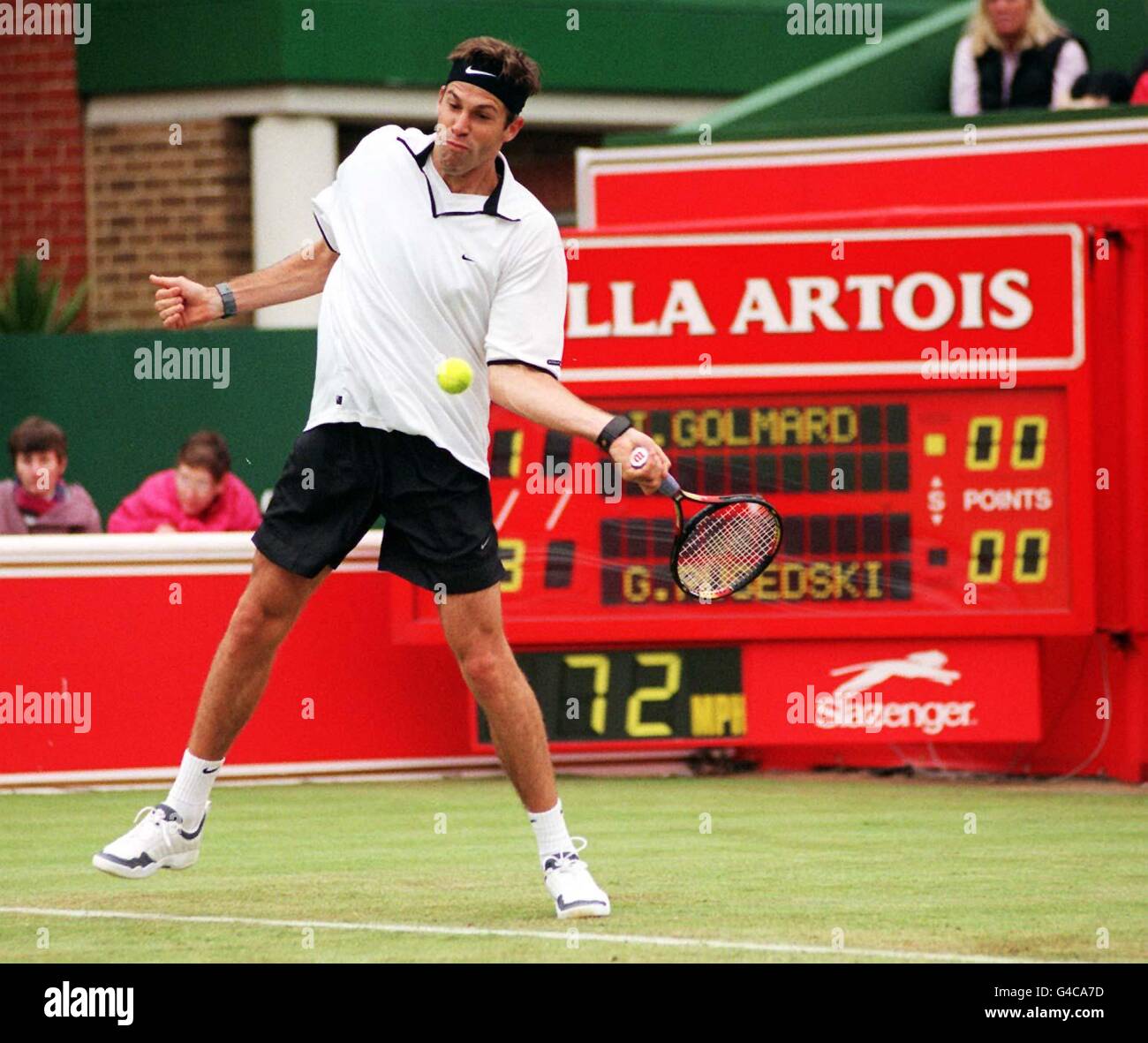 England's Greg Rusedski returns the serv of Golmaro during their rain interrupted second set in the Stella Artois Championships at London's Queens Club today (Thursday). Photo by Paul Treacy/PA. Stock Photo