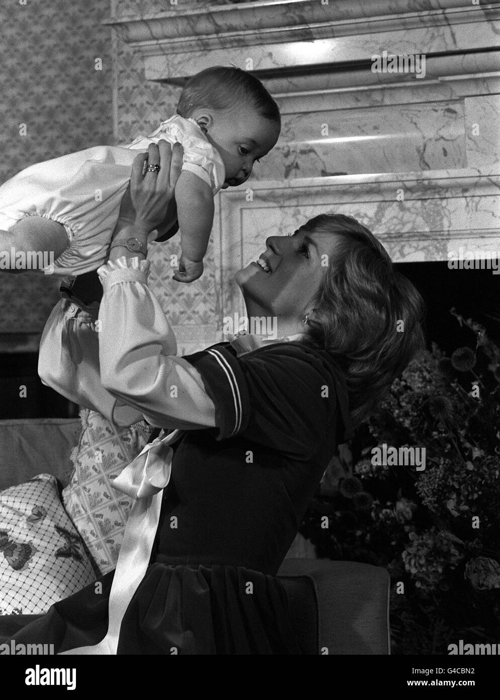 The Princess of Wales lifting her son Prince William at Kensington Palace, London. Stock Photo