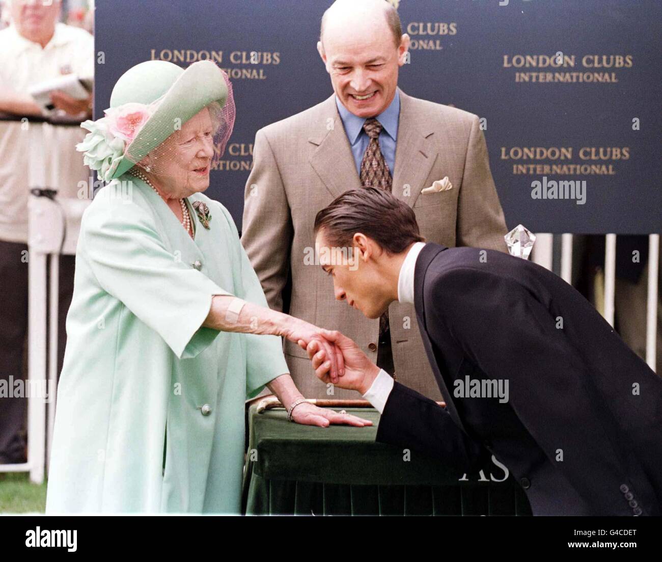 Jockey, Frankie Dettori, kisses the Queen Mother's hand after she presented him with the 'London Clubs Trophy' for the leading rider at Ascot today (Saturday). The Italian has amassed an impressive seven victories over the four days of the Royal Meeting. Photo by Tom Hevezi/PA Stock Photo