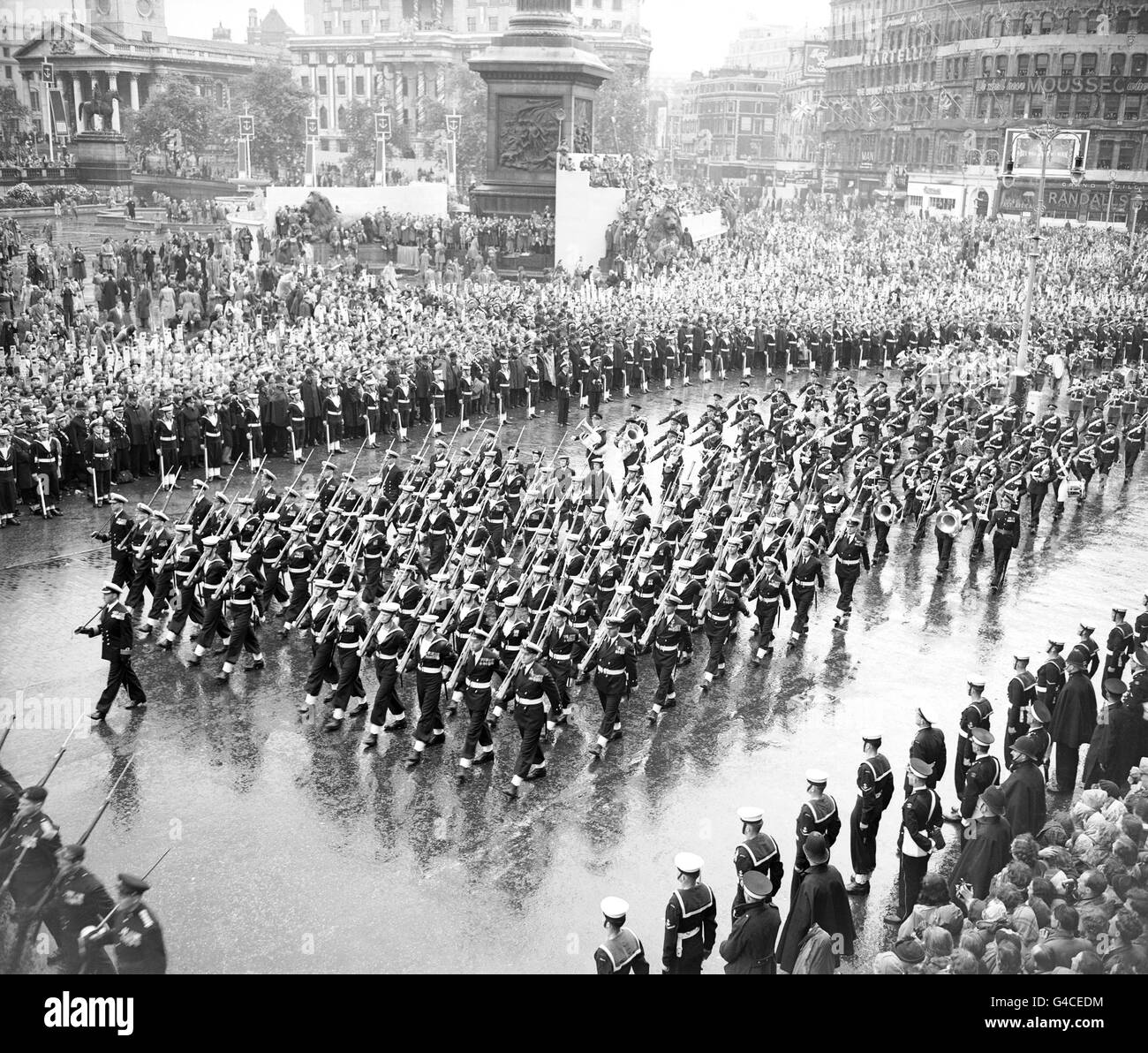 The Royal Navy passes Nelson's Column in Trafalgar Square on the march from Westminster Abbey to Buckingham Palace after the Coronation of Queen Elizabeth II. Stock Photo