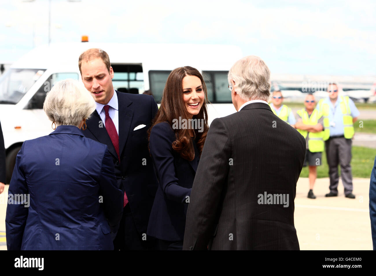 The Duke and Duchess of Cambridge talk to James Wright, the Canadian High Commissioner to the United Kingdom before they board a plane of the Royal Canadian Air Force at London's Heathrow Airport to travel to Ottawa for their first overseas tour as a married couple. Stock Photo