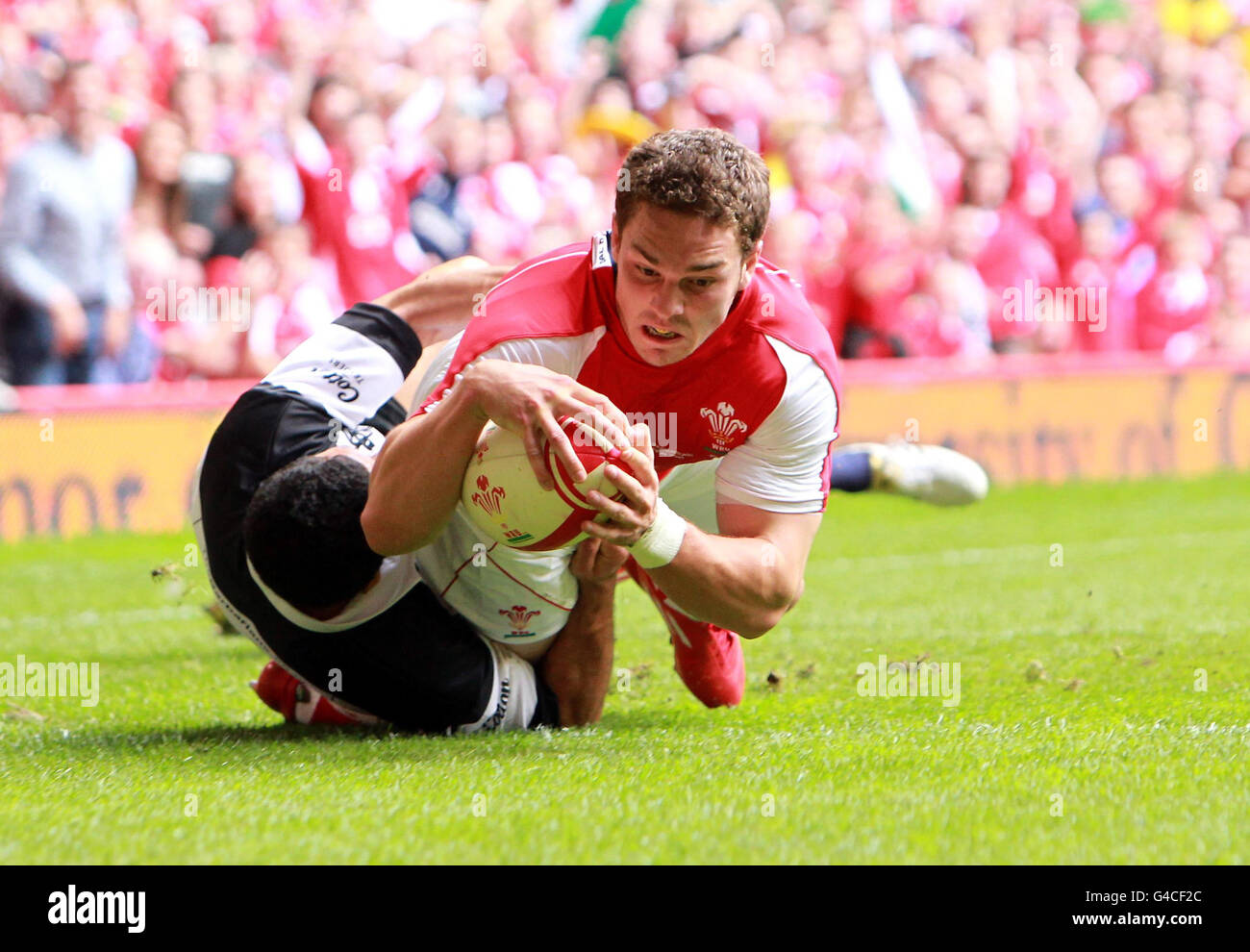 Wales' George North scores the opening try during the 130th Anniversary Celebration Game at the Millennium Stadium, Cardiff. Stock Photo