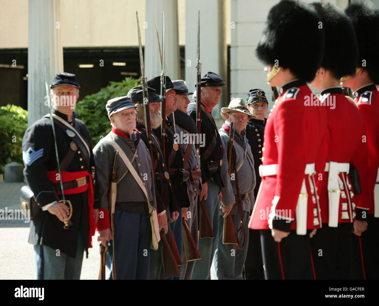 Members of The Southern Skirmish Association (SoSkAn) American Civil War Re-enactment Society with soldiers from the Grenadier Guards, during the launch of The British Military Tournament at Wellington Barracks in central London. Stock Photo